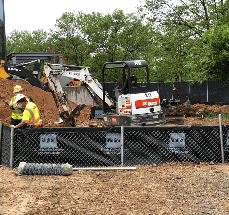 Muller, Inc. crews install super silt fence at construction site.